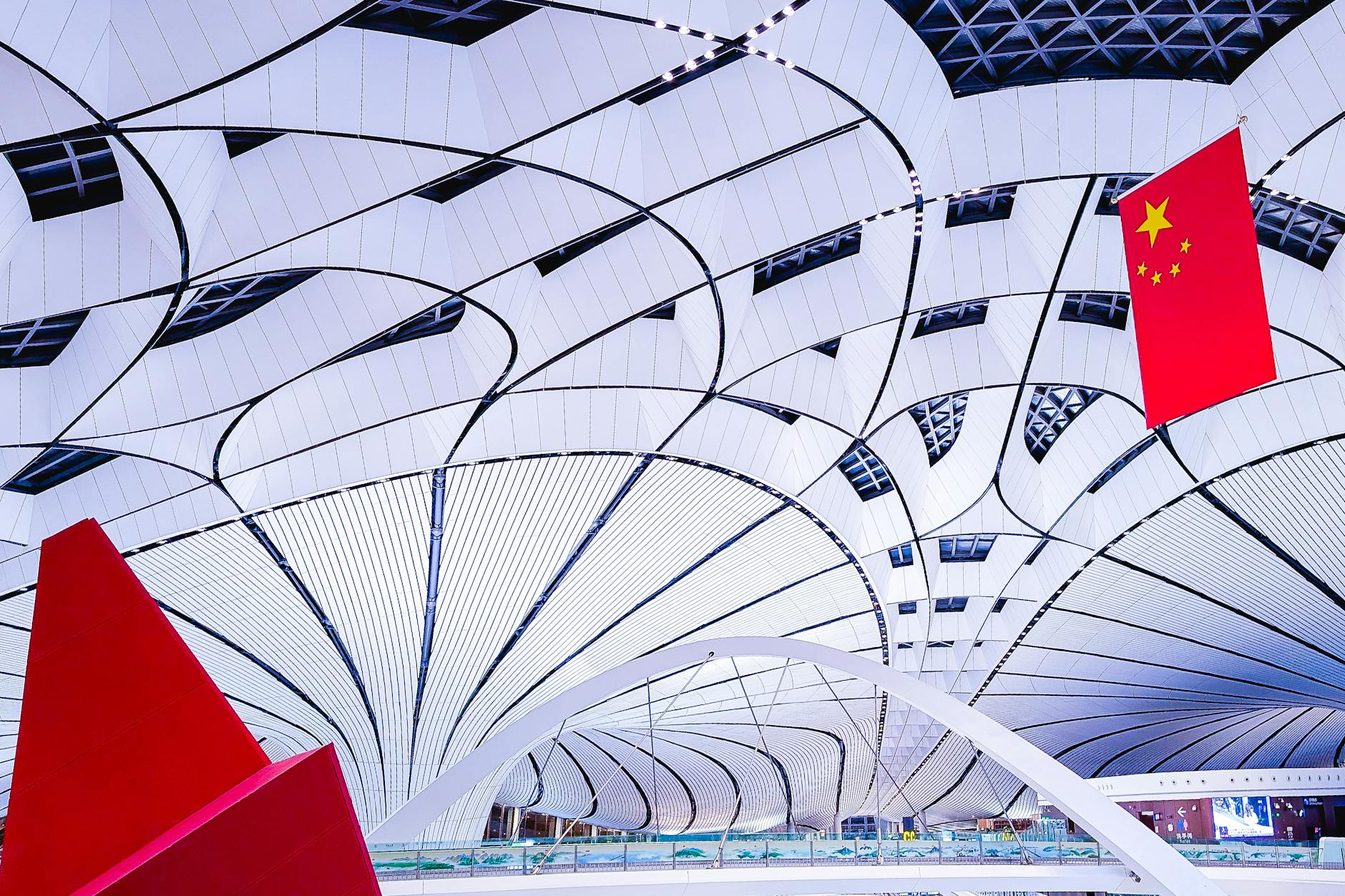 Explore the sleek and modern architectural design of Beijing Airport's interior with its iconic features and vibrant ambiance.
